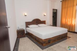 Postel nebo postele na pokoji v ubytování Induwara Villa + 6 fotografií