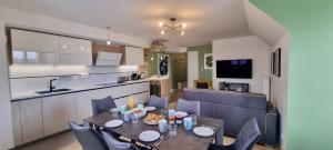a kitchen and dining room with a table and chairs at Sur un Nuage by Plaza in Serris