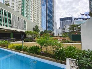 a swimming pool in a city with tall buildings at Cebu Avida Riala T4 2320 IT Park in Cebu City