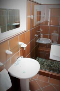 a bathroom with a white sink and a shower at LêPlek Guesthouse in Saldanha +31 photos