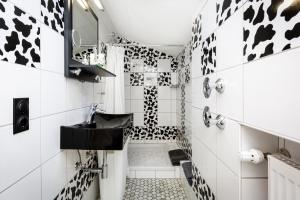 a black and white bathroom with a sink and a shower at In der Leite in Oberstdorf
