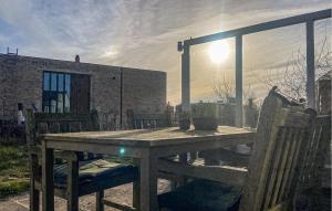 a wooden table and chairs on a patio at Bellevue in Bergen aan Zee +11 photos