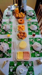 una mesa con queso y otros alimentos. en Quarto De Casal Econômico en Ouro Preto