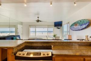 a kitchen with a counter top with a view of the beach at 101-luxury1 in San Diego