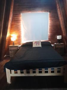 ein Schlafzimmer mit einem großen Bett und einem Fenster in der Unterkunft Chacaimanta RIVERA in Rivera