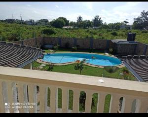 a view of a swimming pool from a balcony at Lisa Mari in Mombasa