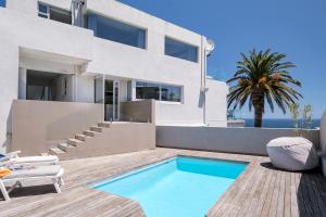 a villa with a swimming pool and a house at Houghton Steps in Cape Town