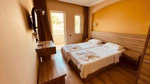 a bedroom with two beds and a window at HAVANA HOTEL in Kemer