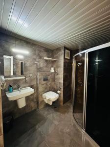 a bathroom with a toilet and a sink and a shower at HAVANA HOTEL in Kemer
