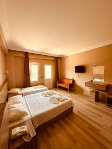 a bedroom with a large bed and a chair at HAVANA HOTEL in Kemer