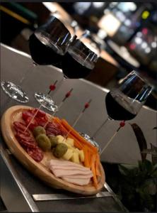 a sandwich with meat and vegetables and two glasses of wine at Hotel Algo in Tirana