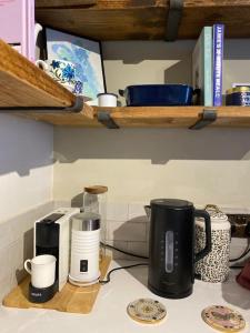 a kitchen counter top with a coffee maker and cups at Luxurious quirky 2bedroom house in Southampton