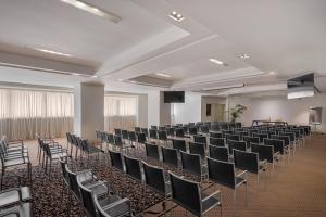 a room with rows of chairs and a podium at Palace Catania | UNA Esperienze in Catania