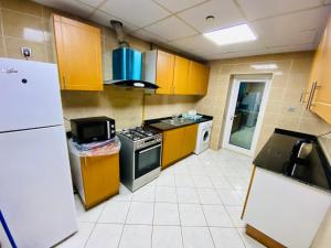 a kitchen with yellow cabinets and a stove at Panoramic Partation with Amazing View close to Mall Of Emirates in Dubai