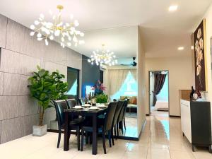 a dining room with a black table and chairs at Eden Height Cozy & Spacious Condominiums in City of Kuching in Kuching