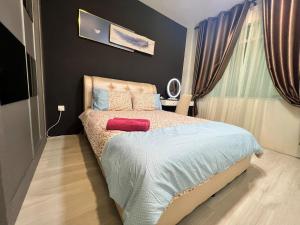 a bedroom with a bed in a room with curtains at Eden Height Cozy & Spacious Condominiums in City of Kuching in Kuching
