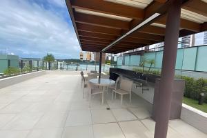 a balcony with a table and chairs on a building at Atlantis Cabo Branco by Allmare Apartamentos in João Pessoa