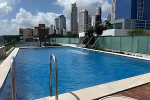 a swimming pool on top of a building with a city skyline at Atlantis Cabo Branco by Allmare Apartamentos in João Pessoa