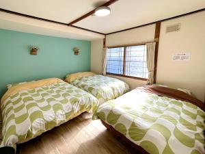 A bed or beds in a room at Mint / 11min walk to Noboribetsu st