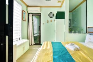 a bedroom with a bed and a bathroom at Golden V Primera Unit A in Malolos
