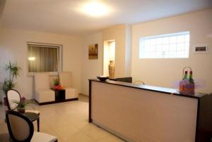 a lobby with a bar in a room at Ammolithos Beach in Stavros