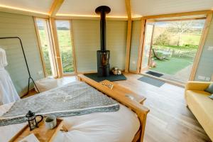 a bedroom with a woodburning stove in a house at Hex at Hollands Farmhouse in Dorchester