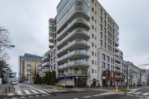 a tall building on a city street with a street at Siedmiogrodzka 7 by Homeprime in Warsaw