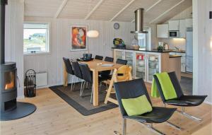 a kitchen and dining room with a table and chairs at Cozy Home In Haderslev With Wifi in Flovt
