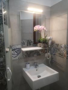 a bathroom with a white sink and a mirror at Casa vacanza da Samuele in San Vito lo Capo