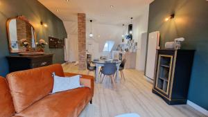 a living room with a couch and a table at Le Colombier in Laon