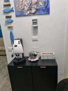 a sewing machine on a black counter in a room at Taormina Roby Casa Vacanze in Giardini Naxos
