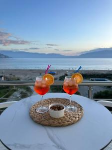 a table with three drinks on top of a table at Sea View Apartment Luxury in Vlorë