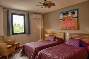 a bedroom with two beds and a window at Souleia in Oppède +27 photos