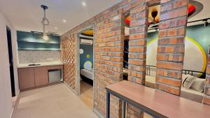 a brick wall in a room with a kitchen at Seeds Hotel Ampang Point in Kuala Lumpur