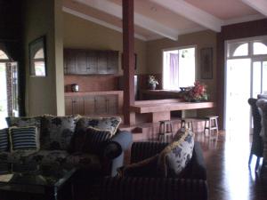 a living room with two couches and a table at Villa Tjokro in Puncak