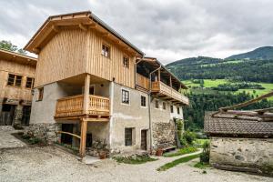 a large building with wooden balconies on top of it at Bergchalet Lanthalerhof in San Martino