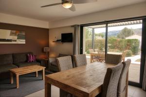 a living room with a table and a couch at Souleia in Oppède