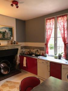 a kitchen with a stove and a sink and a window at LA FERME DU PAVILLON in Sainte-Croix-du-Mont