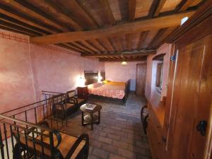 a bedroom with a bed and chairs in a room at La Terrazza in Montecastelli