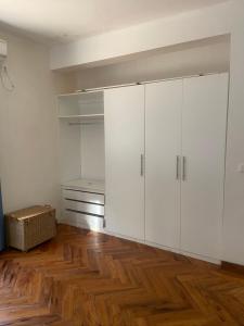 an empty room with white cabinets and a wooden floor at House 16 - Kweli and Kael in Chavanine