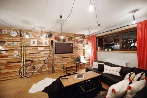 a living room with a couch and a bike in it at Alpini Apartamenty in Zakopane
