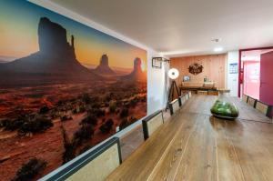 a room with a large painting on the wall at Hotel Le Ranch in Brûlon