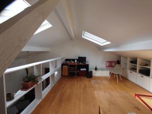an attic room with a desk and skylights at Appartement Paris in Paris