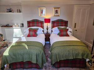 two beds sitting next to each other in a room at Craggan in Ballater