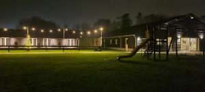 a playground in a park at night with lights at Timmershoeve in Vorstenbosch