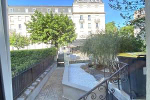 a view of a building from a balcony at Le Pavillon Lorrain in Vittel