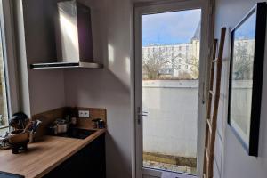 a kitchen with a sink and a window at Le Pavillon Lorrain in Vittel +3 photos