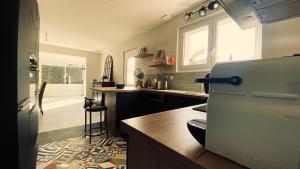 a kitchen with a refrigerator and a counter top at Maison montoison in Montoison