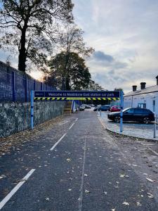 a parking lot with a sign that reads welcome to melbourne car museum of art at Cozy Studio in Maidstone Town Centre in Kent