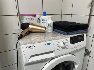 a washing machine with a hair dryer on top of it at Tilava huoneisto in Lahti +5 photos
